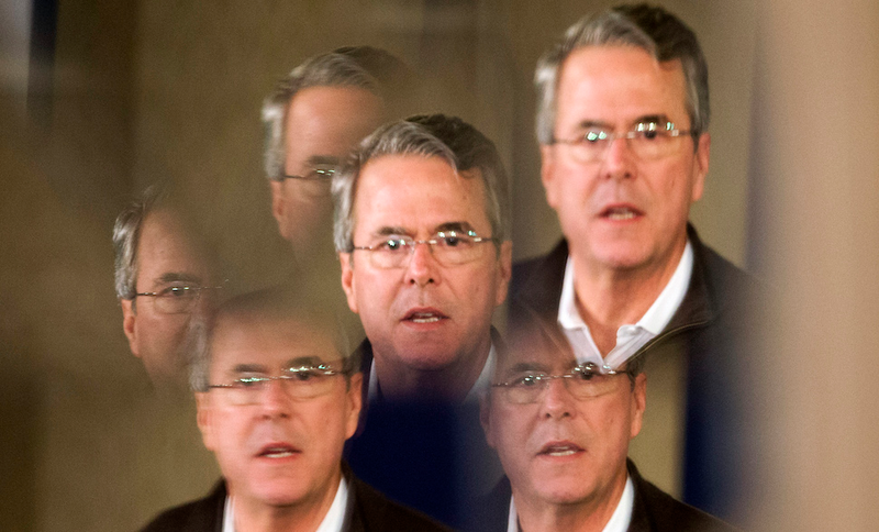 Jeb Bush, reflected in mirrored panels, speaks at a town hall meeting in Laconia, N.H. on Feb. 3, 2016.